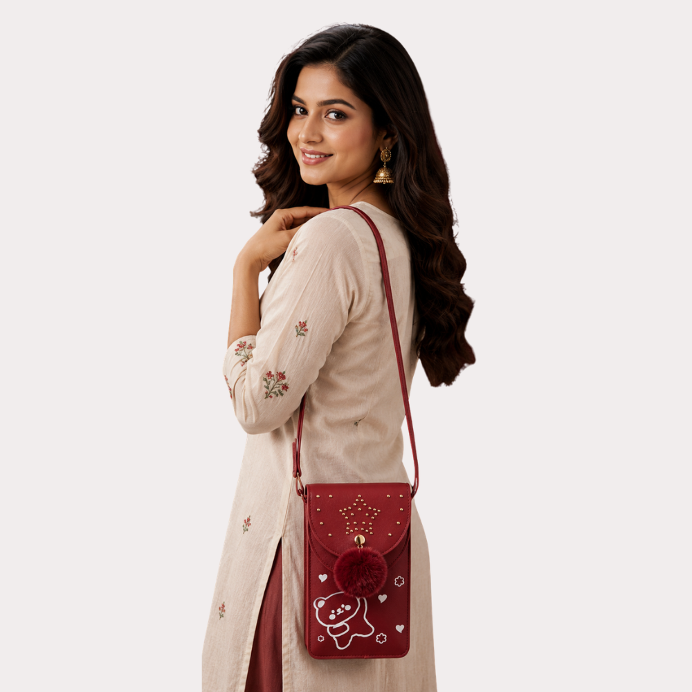 13ZR97NMHBniWuvZHoXDkVa3yqRqj9D1tY6idIwo.png Ruby Star Pom-Pom Mobile Sling Bag - Image 1